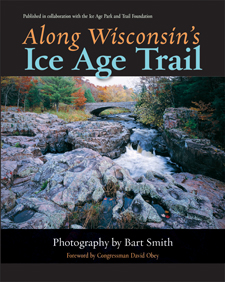the cover of Smith's book is black, with an inset color photo of the trail where it crosses a rocky Wisconsin stream by an arched bridge.